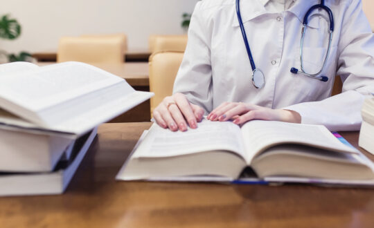 background a medical student for textbooks. The study of surgery by a beautiful girl in the library